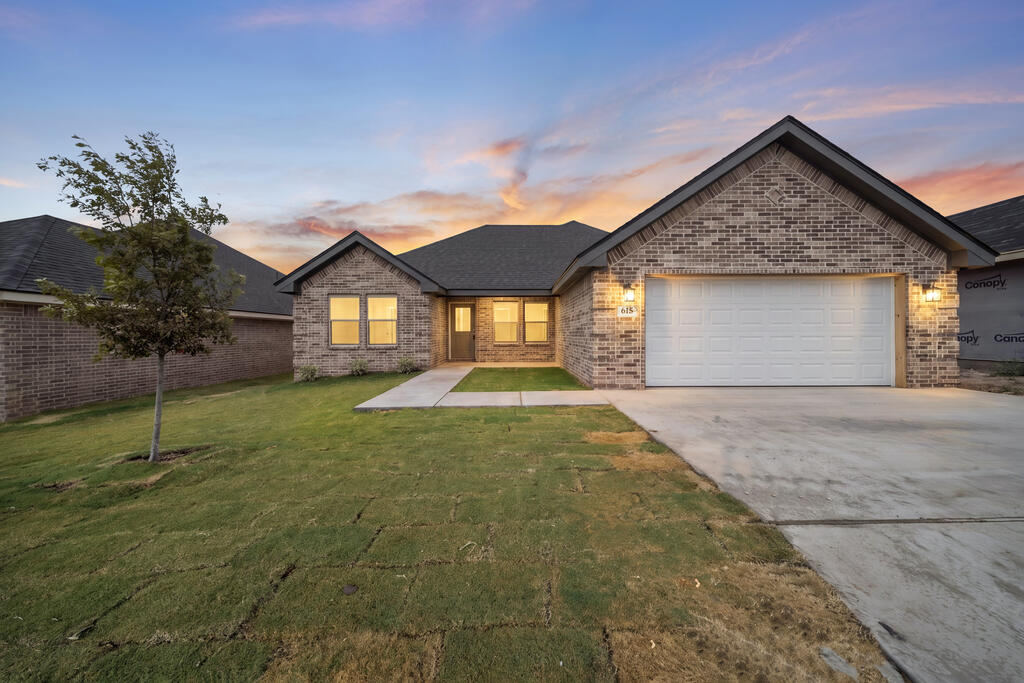 New brick spec home at 615 Ridgeroad Dr in Big Spring, Texas, at dusk